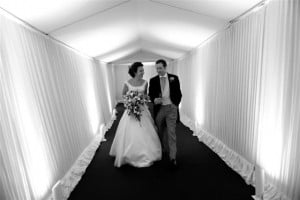 Couple in marquee walkway at wedding