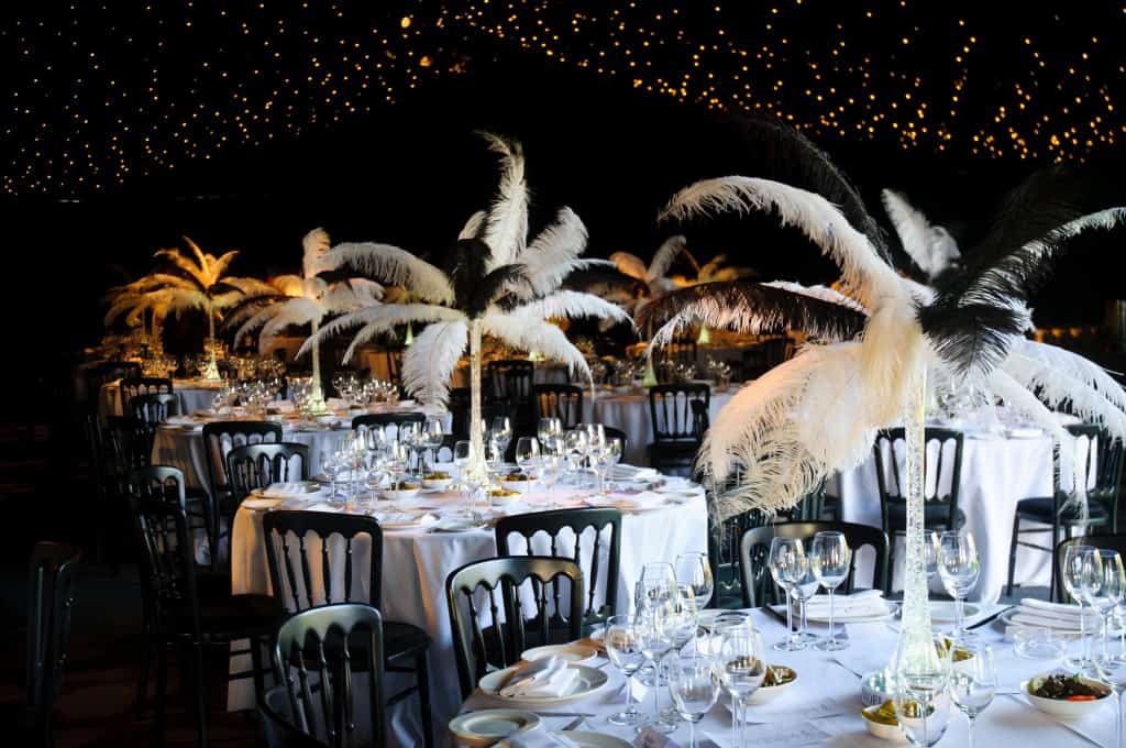 a table set for a party with black and white marquee great Gatsby decor