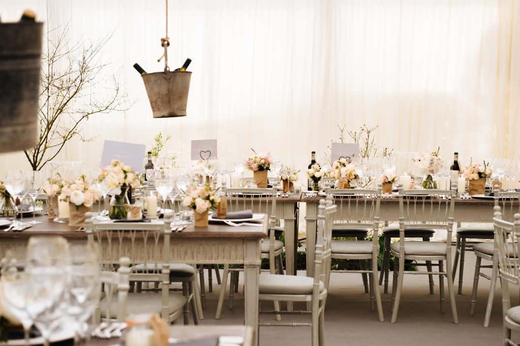 a table set for a wedding reception in a luxury marquee. Marquee wedding themes
