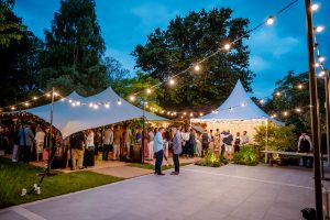 Marquee event planning marquees at night with festoon lighting marquee hire in Weybridge. Lighting powered by a generator. A perfect party venue alternative